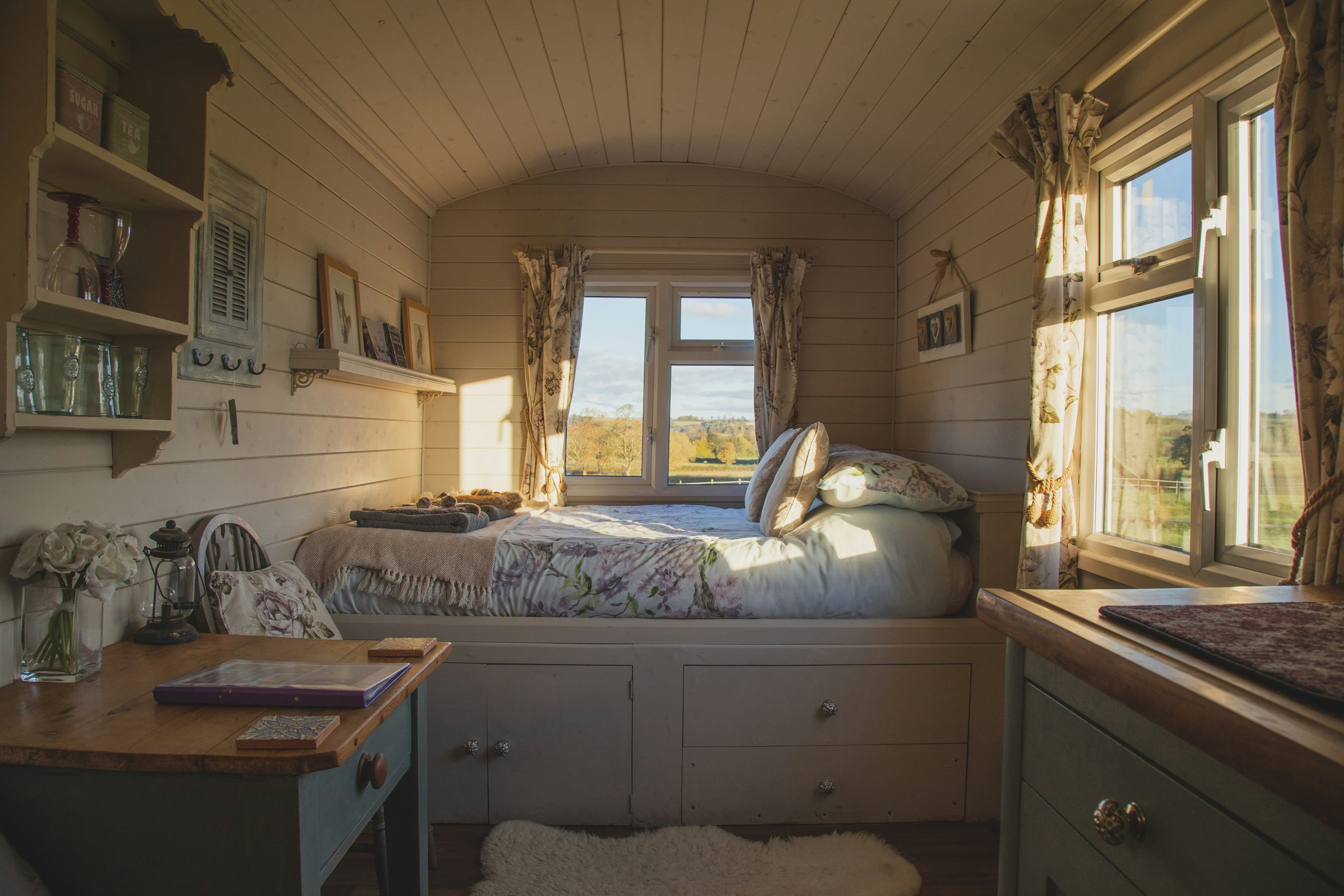 Well-styled Airbnb bedroom with natural light, clean bedding, and warm tones